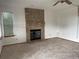 Comfortable living room with brick fireplace and light-filled window at 4812 S Bahama Way, Aurora, CO 80015