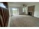 Spacious living room with a brick fireplace and sliding door leading to outdoor deck at 4812 S Bahama Way, Aurora, CO 80015