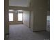 Spacious living room featuring neutral carpet, fresh paint, and abundant natural light throughout at 4812 S Bahama Way, Aurora, CO 80015