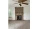 Comfortable living room with brick fireplace and ceiling fan at 4812 S Bahama Way, Aurora, CO 80015