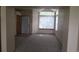 Spacious living room with neutral carpet, bright windows, and fresh, neutral paint colors at 4812 S Bahama Way, Aurora, CO 80015