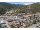 A mountain town aerial view features mountain views, highways, and local businesses amidst houses at 1104 Miner St, Idaho Springs, CO 80452