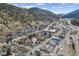 Picturesque aerial view of a charming neighborhood nestled among rolling hills and mountains at 1104 Miner St, Idaho Springs, CO 80452