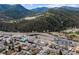 A mountain town aerial view features highway access, businesses, and local homes with lush, green mountain backdrops at 1104 Miner St, Idaho Springs, CO 80452