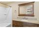 Updated bathroom with granite vanity top, framed mirror, shower and tub combination at 1104 Miner St, Idaho Springs, CO 80452