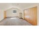 Carpeted bedroom with a window view features a spacious closet and neutral tones throughout the space at 1104 Miner St, Idaho Springs, CO 80452