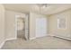 Light bedroom featuring neutral carpet, closet space, baseboard heater, and access to another room at 1104 Miner St, Idaho Springs, CO 80452