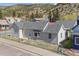 Charming home featuring a well-maintained exterior and a tidy front yard with chain link fence at 1104 Miner St, Idaho Springs, CO 80452