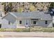 Charming home featuring a well-maintained exterior and a tidy front yard with chain link fence at 1104 Miner St, Idaho Springs, CO 80452