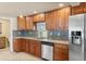 Tasteful kitchen featuring granite counters, tile floors, stainless fridge and wood cabinetry at 1104 Miner St, Idaho Springs, CO 80452