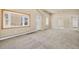 Bright living room view shows neutral walls and carpet plus bay window and open doorways at 1104 Miner St, Idaho Springs, CO 80452