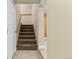 Stairway with carpet, and a wooden handrail leading to the upper level of the home at 1104 Miner St, Idaho Springs, CO 80452