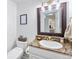 A clean, well lit bathroom with a marbled counter, mirror, and toilet at 13124 Tejon St, Westminster, CO 80234