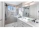 Modern bathroom featuring a glass shower, double sink vanity and light grey tile at 13124 Tejon St, Westminster, CO 80234