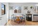 Bright dining area features a hardwood floor, table setting for two, and access to the kitchen at 13124 Tejon St, Westminster, CO 80234