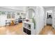 Hallway featuring a dining nook with a round table, hardwood flooring and built-in shelves at 13124 Tejon St, Westminster, CO 80234