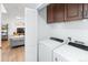 A laundry room with a stacked washer and dryer next to the living space at 13124 Tejon St, Westminster, CO 80234