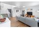 Bright and inviting living room with hardwood floors, a gray sofa, and staircase at 13124 Tejon St, Westminster, CO 80234