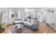 Bright living room with hardwood floors, a comfortable gray sofa, and ample natural light from the window at 13124 Tejon St, Westminster, CO 80234