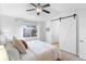 Comfortable main bedroom features a ceiling fan, natural light, and closet with barn door at 13124 Tejon St, Westminster, CO 80234