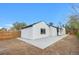 Backyard showcasing fresh landscaping, a white exterior, and a newly poured patio at 2601 W Amherst Ave, Denver, CO 80236