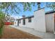Backyard view featuring fresh landscaping, a white exterior, and a concrete patio at 2601 W Amherst Ave, Denver, CO 80236