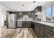 Modern kitchen with stainless steel appliances, sleek countertops, updated cabinets, and luxury vinyl plank flooring at 2601 W Amherst Ave, Denver, CO 80236