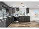 Modern kitchen with stainless steel appliances, sleek countertops, updated cabinets, and luxury vinyl plank flooring at 2601 W Amherst Ave, Denver, CO 80236