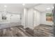 Open-concept space showcases luxury vinyl plank flooring connecting the kitchen, bathroom, and front living areas at 2601 W Amherst Ave, Denver, CO 80236