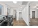 Bright laundry room featuring modern appliances, tile flooring, and an adjacent storage area at 2601 W Amherst Ave, Denver, CO 80236
