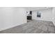 Spacious living room featuring modern gray carpet and bright natural light from a window view at 2601 W Amherst Ave, Denver, CO 80236
