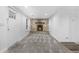 Inviting living area featuring a stunning stone fireplace, carpet, and an open flow to the updated kitchen at 2601 W Amherst Ave, Denver, CO 80236