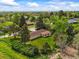 Aerial view of a property surrounded by mature trees and lush greenery in a quiet neighborhood at 2445 Vance St, Lakewood, CO 80214