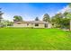 Rear exterior view of the home with a spacious lawn and a patio area, perfect for outdoor gatherings at 2445 Vance St, Lakewood, CO 80214