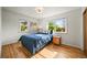 Sunny bedroom featuring hardwood floors, windows with views, and a classic color palette at 2445 Vance St, Lakewood, CO 80214