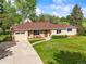 Charming ranch-style home featuring a well-maintained lawn, brick accents, and an inviting front porch at 2445 Vance St, Lakewood, CO 80214