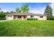 Charming single-story home showcasing a well-manicured lawn and a welcoming front porch at 2445 Vance St, Lakewood, CO 80214