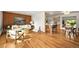 Inviting living room featuring hardwood floors, modern furnishings, and an open layout with a breakfast bar at 2445 Vance St, Lakewood, CO 80214