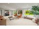 Bright living room featuring modern decor, plush carpeting, and natural light streaming through the large windows at 2445 Vance St, Lakewood, CO 80214