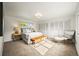 Bright main bedroom featuring neutral decor, a large closet, and a comfortable seating area at 2445 Vance St, Lakewood, CO 80214