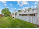 Spacious backyard with green lawn and fencing, providing privacy and room to play at 7483 W Cedar Cir, Lakewood, CO 80226