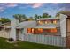 Home's backyard at twilight showcases covered patio and privacy fence, ideal for relaxation at 7483 W Cedar Cir, Lakewood, CO 80226