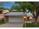 Charming home featuring attached two-car garage, brick accents, and a well-maintained front yard at 7483 W Cedar Cir, Lakewood, CO 80226