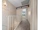 Upstairs hallway with neutral tones and patterned wallpaper at 7483 W Cedar Cir, Lakewood, CO 80226