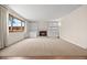 Bright and airy living room features a fireplace with built-in shelving, perfect for modern living at 7483 W Cedar Cir, Lakewood, CO 80226