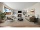 Inviting living room with a cozy fireplace and built-in shelving, perfect for relaxing and entertaining at 7483 W Cedar Cir, Lakewood, CO 80226