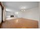 Spacious living room featuring hardwood floors, built-in bookshelves, and a fireplace at 7483 W Cedar Cir, Lakewood, CO 80226