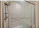 Modern walk-in shower with sleek tile and a rainfall showerhead, offering a spa-like experience at 7483 W Cedar Cir, Lakewood, CO 80226