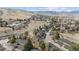 A scenic aerial view of the property showcasing its location amidst mountains, trees, and residential area at 138 S Holman Way, Golden, CO 80401