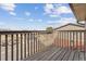 A wood-floored balcony overlooking the neighborhood streets, surrounded by wood railing, under a blue sky at 138 S Holman Way, Golden, CO 80401